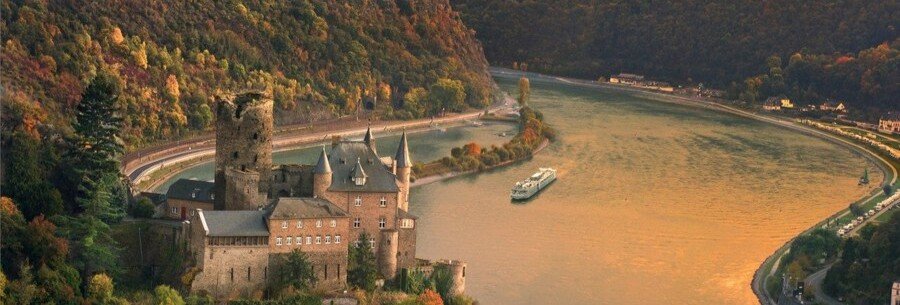 Burg Katz castle overlooking the Rhine Gorge near St Goarshausen with a river cruise ship sailing below
