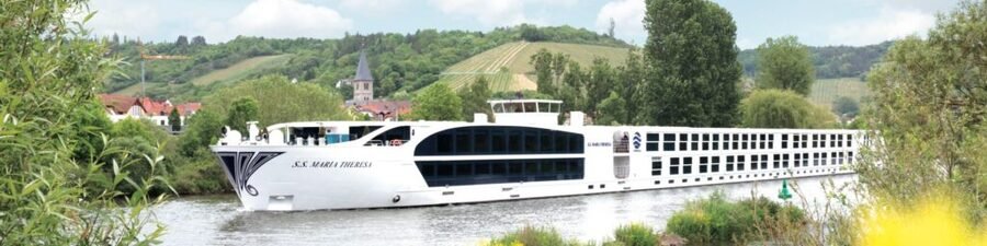 Rhine River cruise ship sailing past vineyards and countryside along the Rhine River in Germany