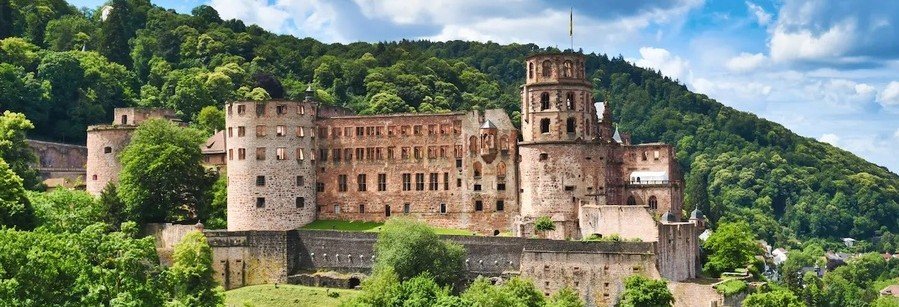 Heidelberg Castle overlooking the Old Town and green hills above the Neckar River in Heidelberg Germany