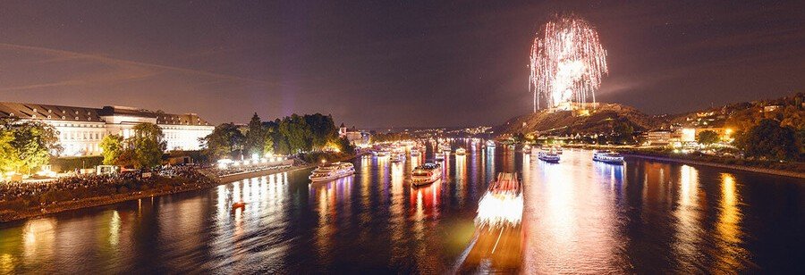 Rhine in Flames fireworks over the Rhine Gorge with illuminated cruise ships and glowing castles in Germany